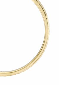 Gold-tone circular frame with a wavy edge design. Smooth, shiny surface; minimalist aesthetic highlighting clean lines and reflective quality.