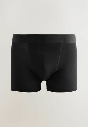 Juodi medvilniniai apatiniai trumpikės stiliaus, su analogišku elastiniu liemeniu, išspaustu prekės pavadinimu. Lygios tekstūros ir prigludusio dizaino.