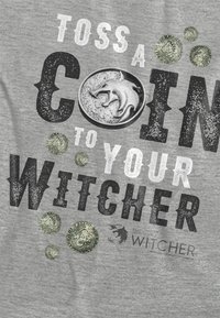 Gray fabric with bold black and white text: "TOSS A COIN TO YOUR WITCHER." Includes a circular coin graphic and smaller coin designs.