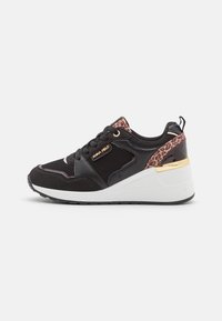 Black athletic sneaker with mesh and suede materials, leopard print accents, gold hardware, and a white wedge sole. Ribbed heel detail.
