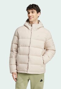 Light beige puffer jacket with a hood, quilted sections, and a front zipper. Textured fabric and subtle branding visible on the chest.
