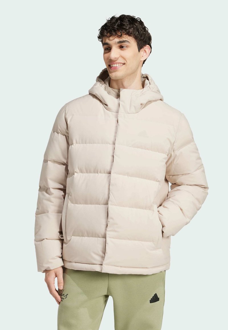 Light beige puffer jacket with a hood, quilted sections, and a front zipper. Textured fabric and subtle branding visible on the chest.