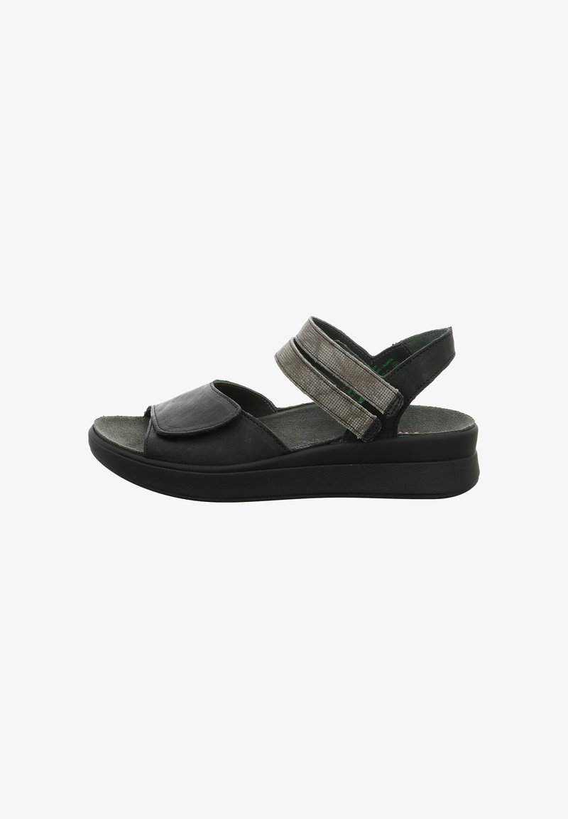Black open-toe sandal with adjustable wide straps over the foot and around the ankle, cushioned sole, and slight wedge heel.