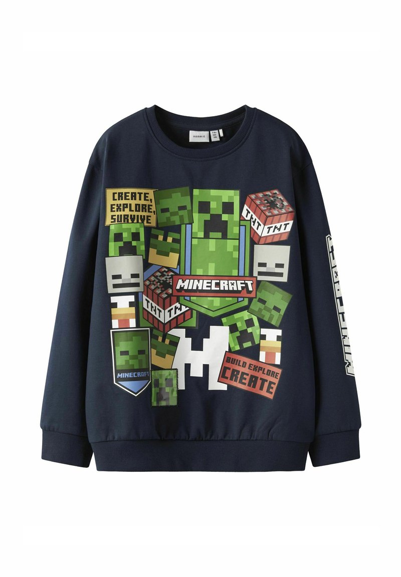 Sudadera de color azul marino con diseños pixelados de Minecraft, que incluyen Creepers y TNT, con elementos de texto en varios colores y formas.