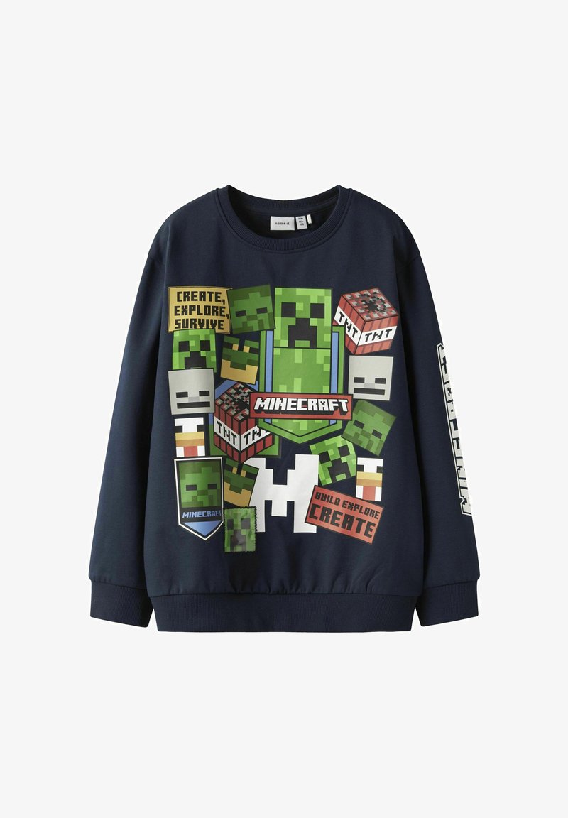 Sudadera de color azul marino con diseños pixelados de Minecraft, que incluyen Creepers y TNT, con elementos de texto en varios colores y formas.