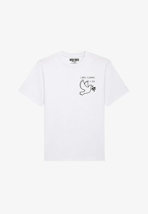 Witte katoenen t-shirt met een zwarte omtrek van een duif en de tekst "LIBRE COMME L'AIR" op de linkerkant van de borst. Korte mouwen, ronde hals.