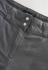 Gray cotton blend trousers featuring a flat waistband, two silver snaps, and double stitching along the seams for added durability.