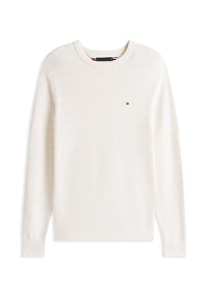 Pull crème clair avec un design rayé texturé, col rond et petit logo brodé sur la poitrine gauche. Matière en tricot douce.