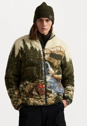 Fleece jacket with a scenic wilderness print in green, beige, and blue. Features a zip closure and a textured, cozy surface. Brown patch accent.