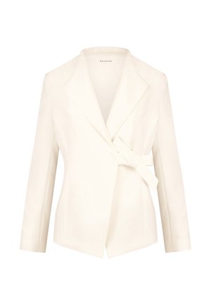 White tailored blazer with a shawl collar, wrap front, and side tie. Made of smooth fabric, featuring long sleeves and structured shape.