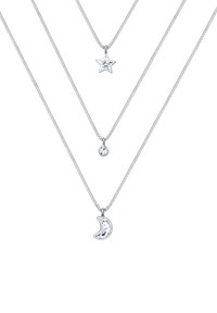 Tre lager av halsband i silver med en stjärna, måne och rund berlock, prydda med kristaller, på fina, eleganta kedjor.