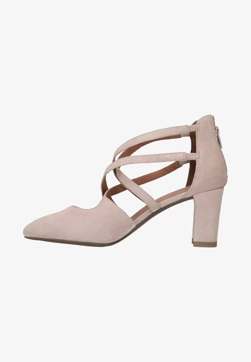 Scarpa con tacco alto in suede rosa chiaro, con punta affusolata, caratterizzata da molteplici cinturini incrociati e un tacco spesso. Texture liscia, design elegante.