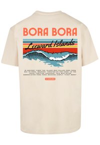 Beige cotton t-shirt featuring a graphic design with “BORA BORA” text, waves, and striped background in blue, orange, and red colors.