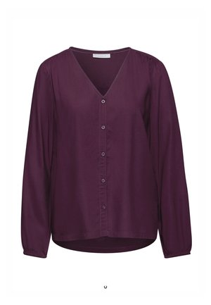 Blusa de manga larga con cuello en V en púrpura profundo, hecha de una tela suave. Presenta botones en la parte delantera, puños fruncidos y un dobladillo ligeramente curvado.