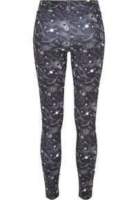 Svarta leggings med ett vitt himmelmotiv av stjärnor, planeter och stjärnbilder, tillverkade av töjbart, slätt tyg.