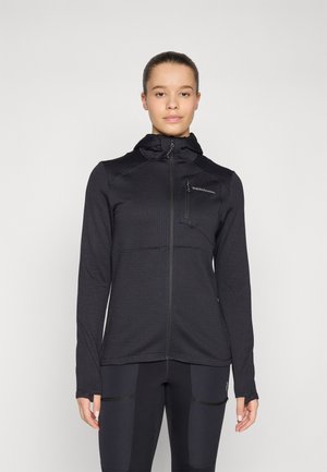 Black zip-up jacket with a textured fabric, hood, and a chest pocket. Features long sleeves and fitted design, paired with black pants.