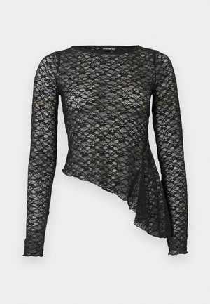 Top noir en dentelle à manches longues avec motif floral, ourlet asymétrique et silhouette ajustée.