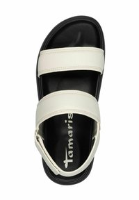 White synthetic sandals with two horizontal straps, a black sole, and a heel strap. Features the brand name "Tamaris" printed in white.