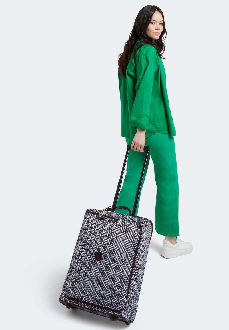 Rolling suitcase with a patterned fabric exterior in navy and white, black accents, and a sturdy telescopic handle.