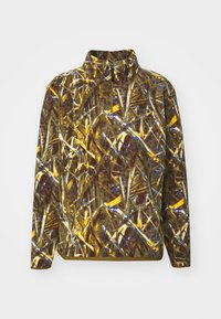 Fleece genser med høy krage i et brunt, gult og blått kamuflasjemønster. Har en frontglidelås og lange ermer.