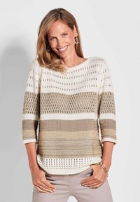 Breisel met gestreepte patronen in beige en crème, met driekwartmouwen en een losse pasvorm. Geopende steekdetails aan de zoom.