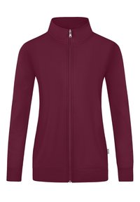 La giacca zip-up marrone scuro presenta un alto collo, maniche lunghe e tasche laterali. Tessuto dall'aspetto liscio con polsini e orlo a coste.