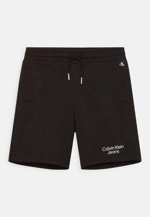 Schwarze Baumwollshorts mit elastischem Bund, Kordelzug, zwei Seitentaschen und weißem "Calvin Klein Jeans"-Logo am linken Bein.
