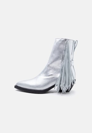 Shiny silver ankle boot with low heel and long fringe detail hanging from the back side.