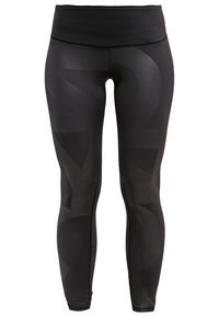 Leggings neri a vita alta, caratterizzati da una texture liscia, modelli geometrici sottili e un design avvitato.