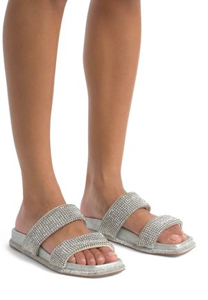 Zilveren glanzende slip-on sandaaltjes met twee brede banden, versierd met rhinestones en een zachte grijze basis. Platte zool, open teen ontwerp.