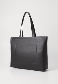 Černá kožená taška přes rameno s dvojitými dlouhými uchy, hladká textura, minimalistický design, obsahující přední kapsu a jemné švy.