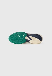 Footwear outsole featuring a multi-color design: green, navy, and cream. Textured patterns and grooves enhance grip and stability.