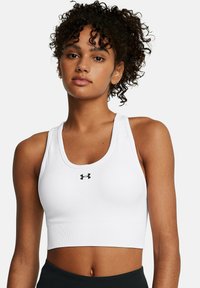 Under Armour VANISH SEAMLESS MID - Medium support sports bra - white
