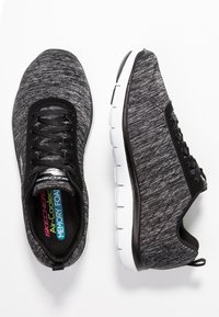 Czarne i szare buty sportowe z teksturowaną cholewką, sznurków oraz białą podeszwą. Wewnątrz znajdują się oznaczenia "Air-Cooled Memory Foam".