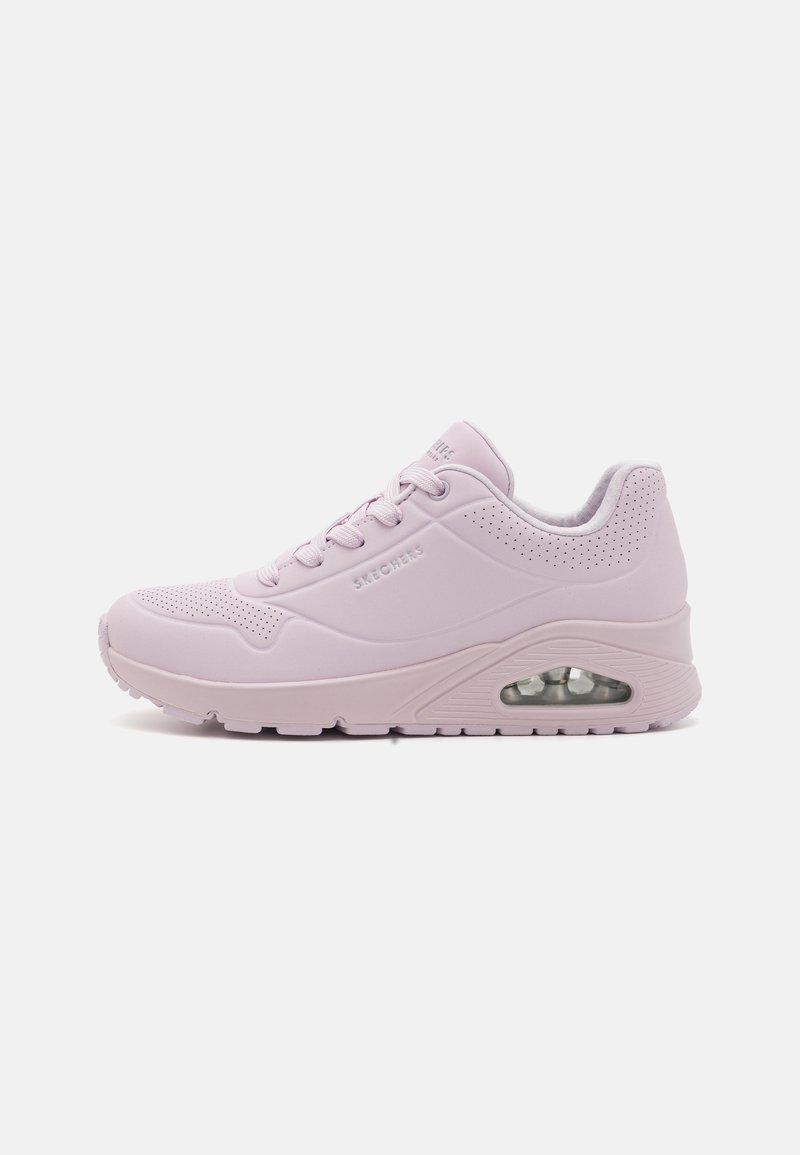 Light pink sneaker with a smooth synthetic upper, perforated details, rounded toe, lace-up design, and a visible air cushioning unit in the sole.