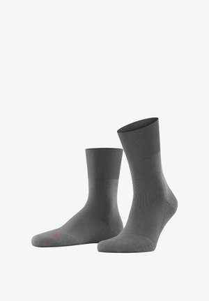 Gray socks made of a smooth material with a ribbed cuff. Notable orange accent on the toe area. Standard crew length.