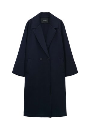 Marineblauer Mantel mit doppelter Knopfleiste, breiten Revers und überschnittenen Schultern. Hergestellt aus strukturiertem Stoff mit zwei vorderen Taschen.