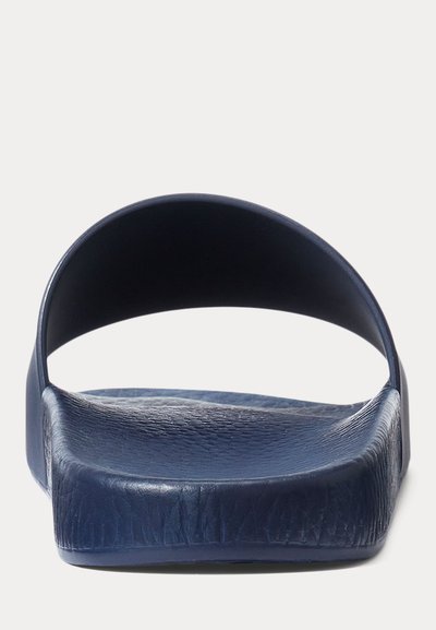 Navy blue slip-on slide sandal with textured footbed and wide strap across the top, shown from front view on a white background.