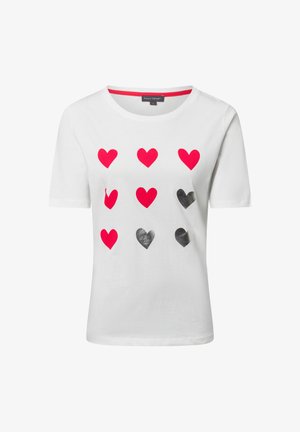 White cotton t-shirt featuring a grid of red and black heart shapes on the front, with a round neck and short sleeves.