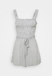 Zwart-wit geruite playsuit met dikke bandjes, vierkante halslijn, getailleerde taille en een strikdetail. Gemaakt van lichtgewicht stof.