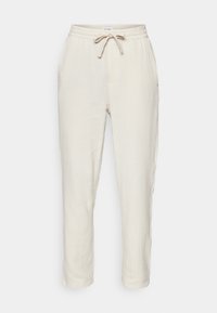 Lichtbeige getextureerde stofbroek met elastische tailleband en verstelbare trekkoord, rechte pijpen en zijzakken.