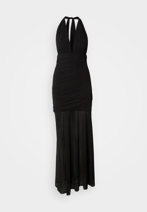 Črna obleka na vrvico z oprijetim zgornjim delom z gubami in tekočo krilom. Izdelana je iz gladkega blaga z elegantnim padcem.