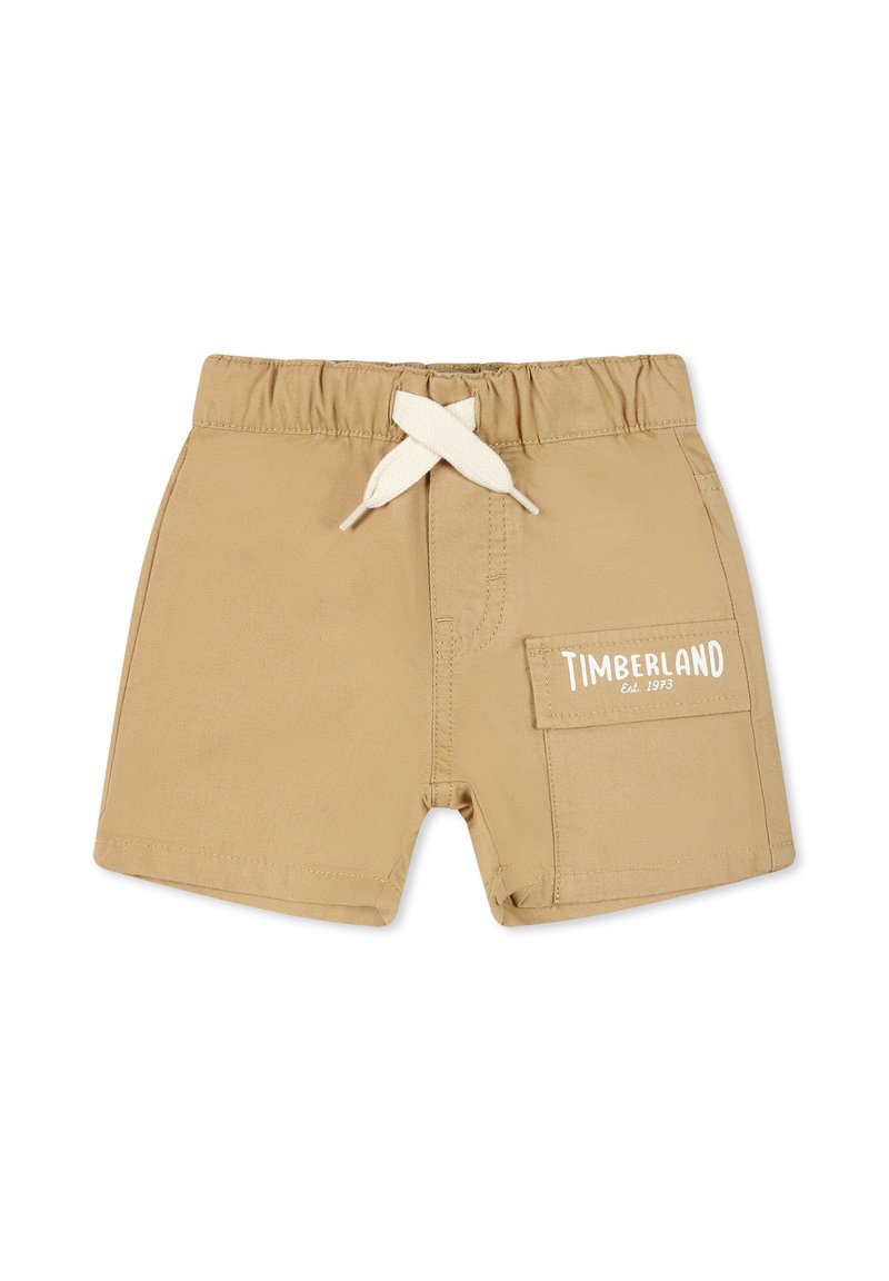 Pantaloni corti color sabbia realizzati in tessuto leggero con cintura elasticizzata e cordino bianco. Presentano una tasca laterale e il logo "TIMBERLAND Est. 1973".