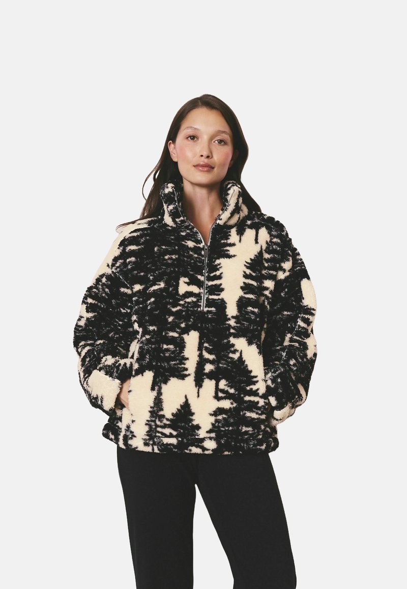 Pulover din fleece în crem și negru cu un model de copaci. Are guler cu fermoar, mâneci lungi și un finisaj moale, texturat. Croi lejer.