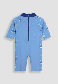 Combinaison néoprène à manches courtes de couleur bleu clair avec fermeture éclair, présentant des motifs de baleines sur les côtés, une texture lisse et un col contrastant bleu foncé.