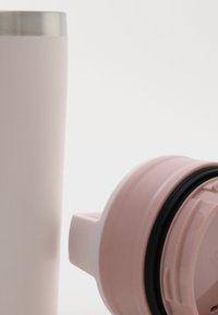 Stainless steel tumbler with light pink exterior and silver lid; includes a pink lid with a black sealing ring and spout for easy drinking.