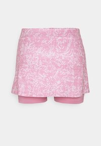 Falda rosa con un patrón abstracto en blanco, con forma de A y pantalones cortos adjuntos debajo para mayor cobertura y comodidad.