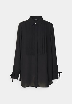 Camisa negra de manga larga con cuello abotonado, frente con pliegues y detalles de corbata en los puños. Fabricada con un tejido ligero y de textura suave.