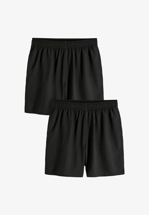 Dve čierne elastické kraťasy s jednoduchým dizajnom, zobrazené na rovine, pričom jeden mierne presahuje druhý na bielom pozadí.