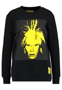 Černá mikina s velkým žlutým grafickým ztvárněním tváře osoby se stylizovanými vlasy, žebrovanými manžetami a malým žlutým logem na lemu.